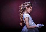 A gorgeous Little Communion girl lost in thought at a portrait session at Cormac Byrne Photography, Limerick. Ireland.  