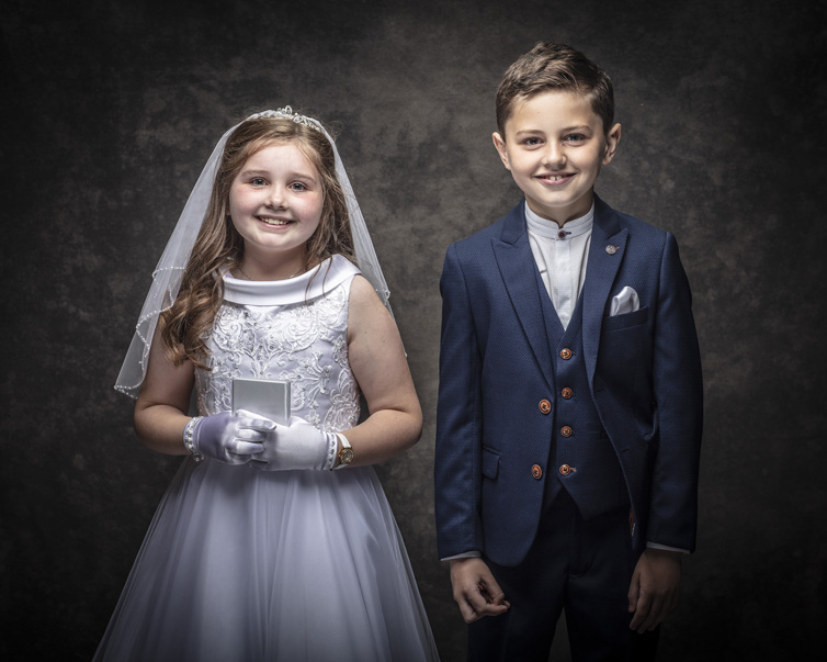Twins having fun at their First Holy Communion portrait session at Cormac Byrne Photography, Limerick, Ireland.  