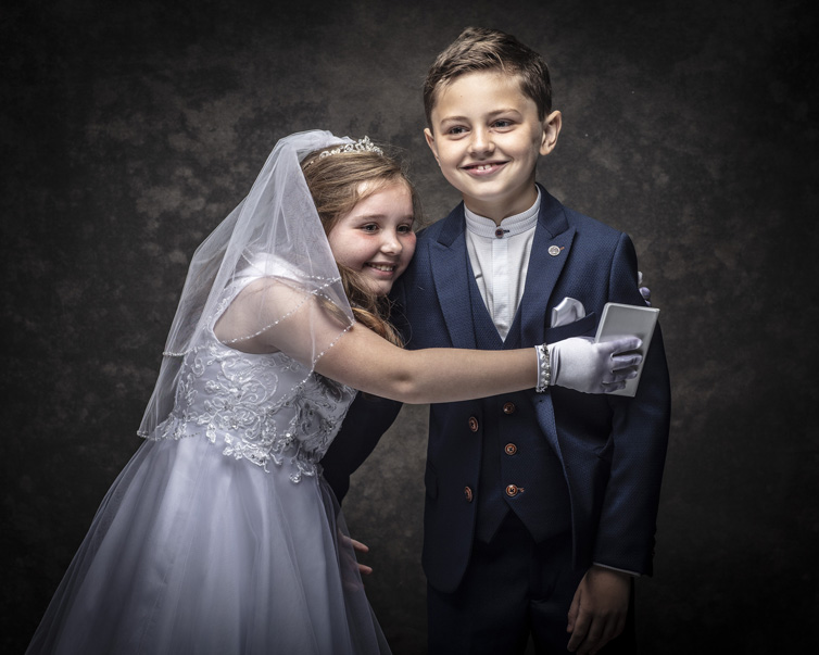 Twins having fun at their First Holy Communion portrait session at Cormac Byrne Photography, Limerick, Ireland.  