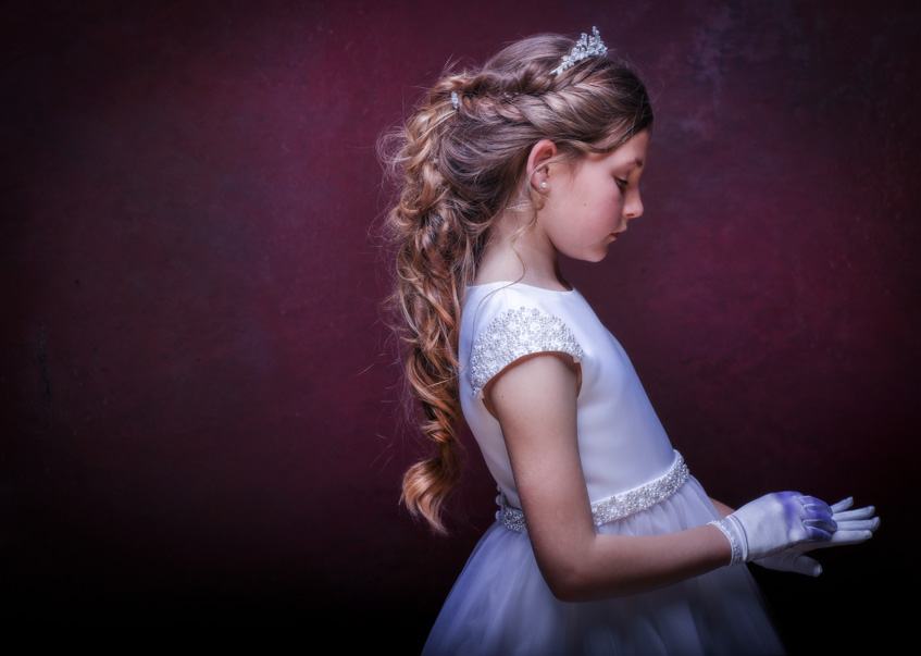 A gorgeous Little Communion girl lost in thought at a portrait session at Cormac Byrne Photography, Limerick. Ireland.  